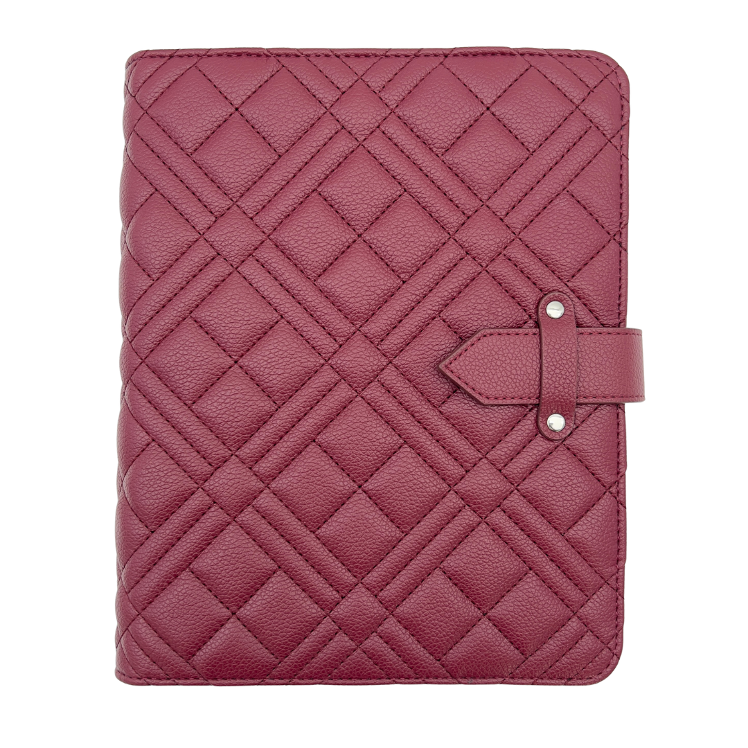 Quilted pink leather cover with a strap on a white background