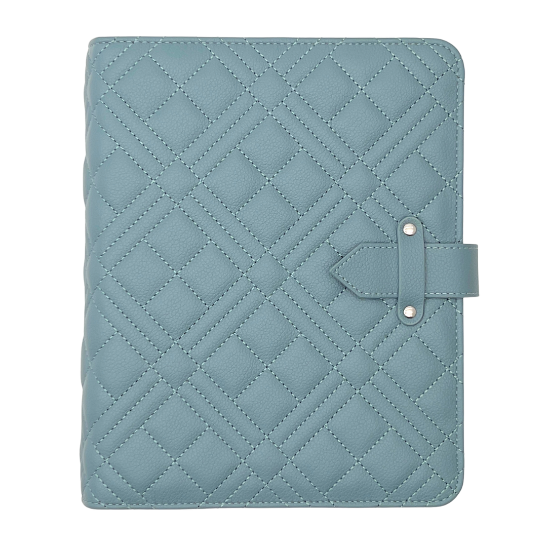 Quilted blue tablet case with a strap on a white background
